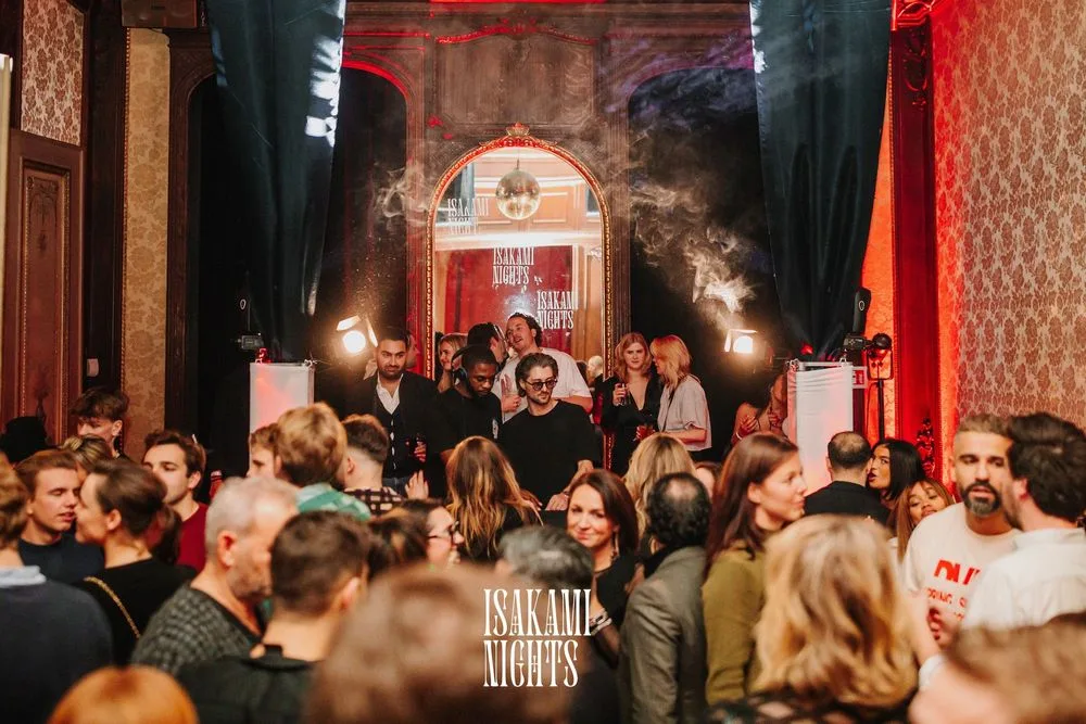 Isakami Nights at Het Leienpaleis, Antwerp — packed crowd in ornate venue with red curtains, smoke and red lighting